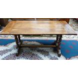 A rectangular walnut refectory table on four turned supports,