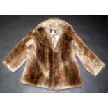 A pale long haired beaver short coat, with label 'Burkholder Furs Ottawa Canada', with customs form.