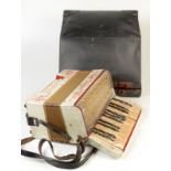 A Pietro piano accordion with twelve buttons, cased, height 34cm.
