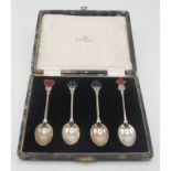 A set of four silver bridge coffee spoons by Walker & Hall, each with an enamel card suit terminal,