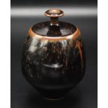 A slender neck bottle vase by Derek Clarkson with tenmoku glaze, impressed mark, height 14cm.