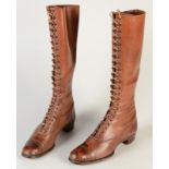 A pair of early 20th century lady's brown leather toecap lace-up boots, each height 41cm.