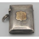 A silver vesta case with a monogrammed 9ct. gold shield, Birmingham 1898.