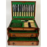 An extensive suite of James Ryals & Co cutlery in an oak canteen with a hinged lid above two