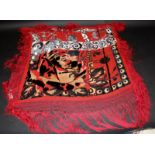 A red silk and crushed velvet shawl, decorated with scroll motifs and foliage, 125 x 121cm.