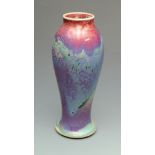 A Ruskin Pottery baluster shape vase with flared foot the red,