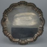 A silver shaped circular tray on four feet, inscribed, London 1934, diameter 35.8cm, 37.2oz.