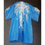 A Chinese blue silk dressing gown with floral decoration.