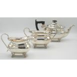 A silver three piece Regency style tea service with bobbin borders and on claw feet, Sheffield 1956,