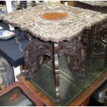 An Indian carved hardwood occasional table, with a folding base, height 61cm.