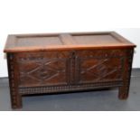 An 18th century oak joined chest, the hinged lid with two plain panels,