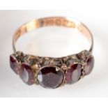 A 9ct. gold Georgian style ring, foil set five garnets.