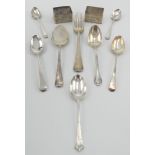 Seven various silver spoons and three forks, together with two engine turned silver napkin rings.
