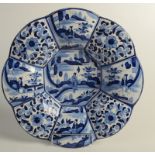 A Delft pottery panelled charger in 'Kraak' style 33cm.
