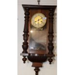 A continental wall clock in a walnut case.