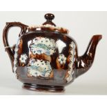 A Victorian treacle glazed Bargeware teapot, moulded with floral sprays, height 17cm.