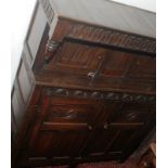 An early 18th century oak press cupboard the canopied upper section with arcaded frieze over two