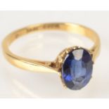 An 18ct. gold ring set a single sapphire.