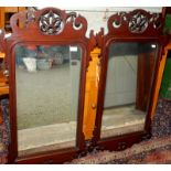 A pair of Chippendale style mirrors, each with shaped, pierced and carved crest and apron.