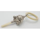 A silver rattle with celluloid ring and mother of pearl teether.