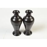 A pair of ebony baluster vases, 15cm.