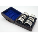 A set of six pierced silver napkin rings, cased.