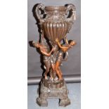 A large reproduction bronze urn, the twin scroll, leaf moulded handles and fluted,