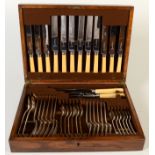 A suite of Poston & Co flatware in an oak canteen.