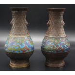 A pair of Japanese baluster shaped bronze vases decorated with champ leve enamel band of birds,