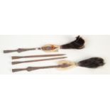 A pair of African arrow heads covered with animal skin, beads and hair, each length 38.