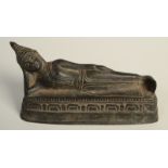 A Burmese bronze figure of Buddha resting supported by the right hand and arm while on a lotus