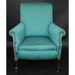 A late Victorian or Edwardian upholstered armchair.