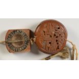 A Japanese carved wood Manju netsuke, decorated to one side with a pavilion and trees,
