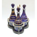 A set of three Regency blue glass decanters labelled with gilding as if a ribbon holds labels for