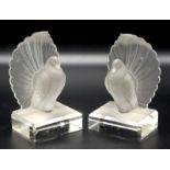 A pair of Lalique style bookends moulded as fantail doves on rectangular, bevelled bases,