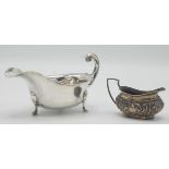 A silver sauce boat and an embossed silver cream jug, 6.5oz.