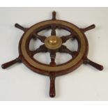 A mahogany ship's wheel, with central brass boss and six turned spokes, diameter 61cm.