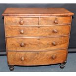 A Victorian mahogany veneered bow front chest of two short and three long graduated drawers.