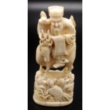 A Japanese walrus ivory okimono, a rock with turtles rising from waves,