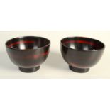 A Japanese pair of bamboo bowls decorated overall with a roiro black lacquer with scattered red