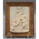 A fine carved ivory panel showing Cupid atop a truncated column, at its base, two puttis, 12.5 x 9.
