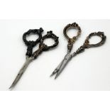 Two pairs of scissors, each with filled silver handles, cased handles loose.