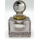 A glass inkwell with silver mount.