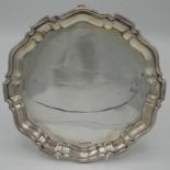 A silver shaped circular tray on four feet by Mappin & Webb, Sheffield 1944, 18.2oz.