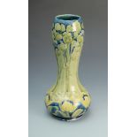 A William Moorcroft 'Tulip' pattern vase with pear shape body and bulbous neck, signed in green W.