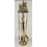 A large brass, four piece fireside companion set,