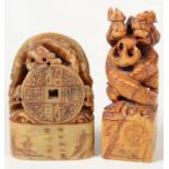 Two Chinese carved soapstone desk seals, height 11cm and 9cm.