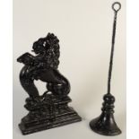 A cast iron rampant lion doorstop and one other iron doorstop.