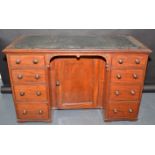 A Victorian mahogany twin pedestal kneehole desk, the top with tooled leather inset,