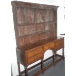An 18th century oak dresser with open rack,